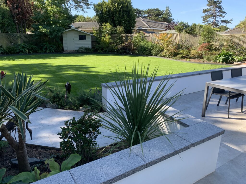 Porcelain patio with rendered retaining walls